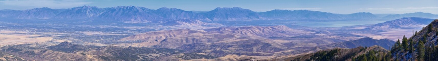 Wasatch Front Rocky Mountain landscapes from Oquirrh range looking at Utah Lake during fall. Panorama views near Provo, Timpanogos, Lone and Twin Peaks. Salt Lake City. United States.