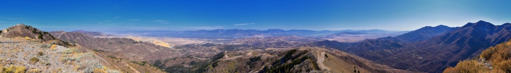 Fototapeta na wymiar Wasatch Front Rocky Mountain landscapes from Oquirrh range looking at Utah Lake during fall. Panorama views near Provo, Timpanogos, Lone and Twin Peaks. Salt Lake City. United States.