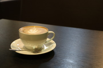 cup of coffee on wooden table