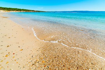 Pebbles and sand in Lazzaretto beach in Alghero