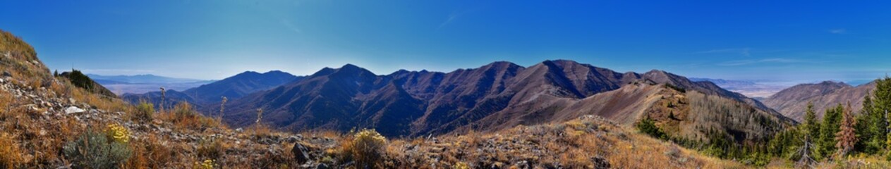 Wasatch Front Rocky Mountain landscapes from Oquirrh range looking at Utah Lake during fall. Panorama views near Provo, Timpanogos, Lone and Twin Peaks. Salt Lake City. United States.