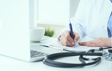 Mid section of female doctor writes prescription to patient at worktable. Panacea and life save, prescribing treatment.