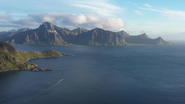 aerial view. flight over the sea,view on the Flakstadoya from Haukland beach and Mannen peak. Camera move left to right .Lofoten Islands,Norway