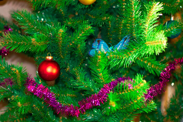 Christmas tree with toys. Christmas toys on a green tree