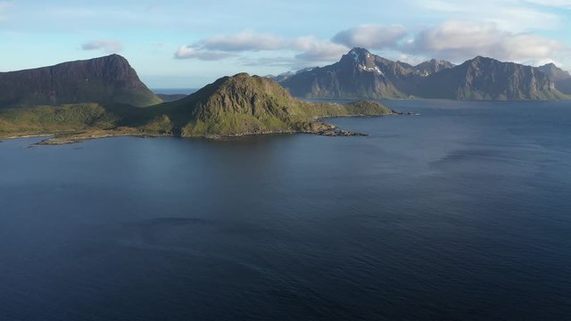 aerial view. flight over the sea,view on the Flakstadoya from Haukland beach and Mannen peak. Camera move left to right .Lofoten Islands,Norway