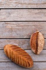Top view of artisan bread on wooden background. Freshly baked homemade bread. Space for text.