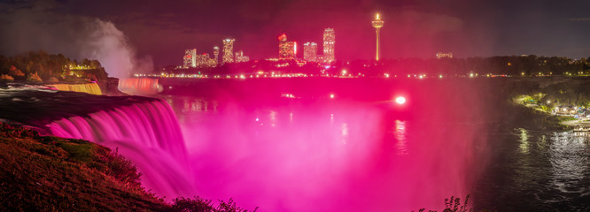 Fototapeta na wymiar Niagara Falls - colorful illuminations of the waterfall. View from American Side