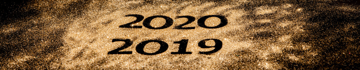 Beautiful sparkling Golden Numbers of 2019 to 2020 on black background for design, happy new year concept
