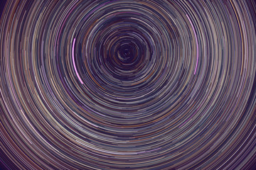 star trails -  light streaks of stars around Polaris in the night sky due to Earth's rotation
