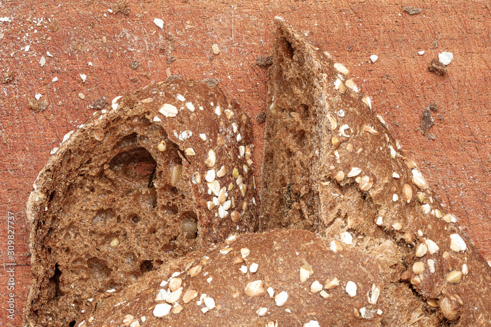 Wall mural delicious handmade wholemeal bread with nuts on a rustic wooden table