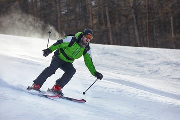 Fototapeta na wymiar Skier going very fast down the slope