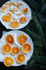 the drying process of sliced oranges on a white plate