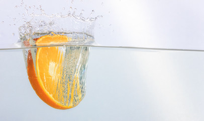 Orange dropping in water