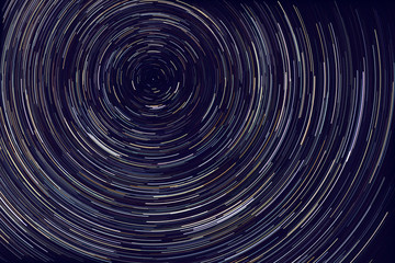 star trails -  light streaks of stars around Polaris in the night sky due to Earth's rotation