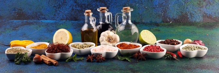 Fototapeta na wymiar Spices and herbs on table. Food and cuisine ingredients with oil and vinegar