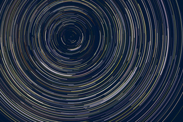 star trails -  light streaks of stars around Polaris in the night sky due to Earth's rotation