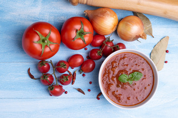 Bolognese with tomato sauce in a white plate on rustic wooden blue table background, soft light