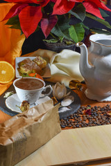 biscuits on the table between plants and coffee with milk and chocolate