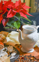 Christmas plant on the table next to teapot