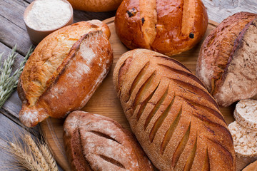 Delicious crispy bread assortment. Fresh homemade bread on wooden background.