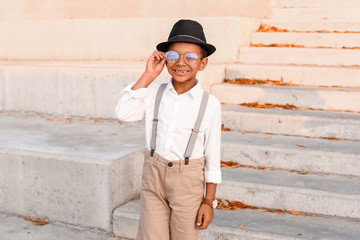 Cute fashionable African-American boy outdoors