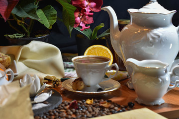 cup of coffee with milk and chocolate on the table surrounded by plants and a bottle of honey