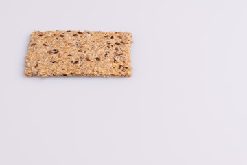 Diet flax seed whole grain crackers isolated on white background, soft light, copy space
