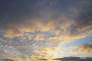 Evening sky, sunset. The last rays of the sun illuminate the sky with clouds.