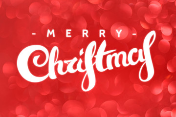 Merry christmas lettering on defocused backdrop with red lights.