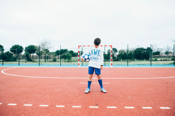 Fototapeta premium Soccer player boy holding the ball by hand