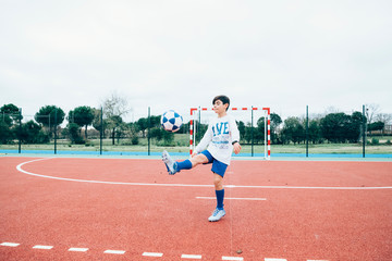 Fototapeta premium Soccer player boy hitting the ball