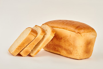 Loaf and slices of white bread. Freshly baked bread.