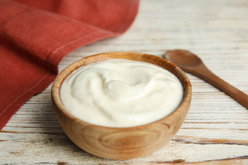 Fototapeta na wymiar Tasty organic yogurt on white wooden table
