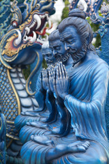 Statues of guards in Chinese style at Wat Rong Suea Ten, or Blue Temple in Chiang Rai Province, Northern Thailand