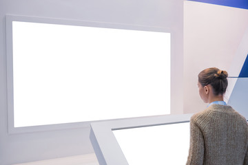 White screen, mock up, future, copyspace, template, isolated, technology concept. Woman looking at...