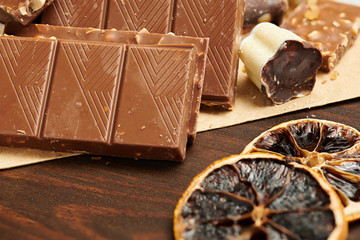 Chocolate bars and homemade candies on rustic table, sweet food, macro photo