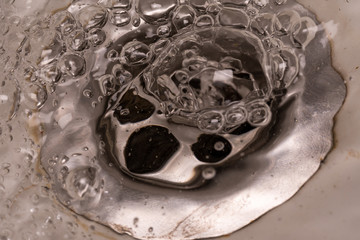 "frozen motion" marcro photography as water drains into the sink