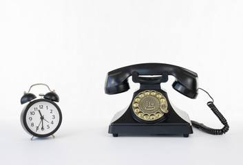 Clock time picking up the phone black rotary telephone white isolated background