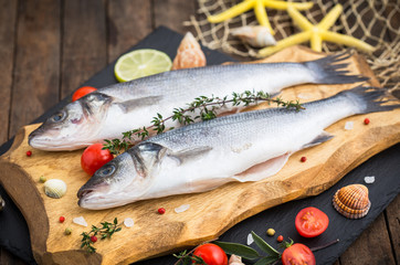 Fresh raw seabass fishon the wooden table
