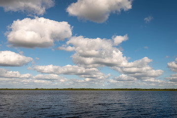 A view of cumulus clouds and  New River Lagoon located east of the Maya Temples of Lamanai.