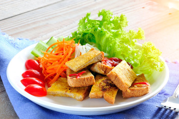 Breakfast plate, breaded bread and fresh vegetables 
