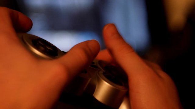 Close up man playing video games on joystick 