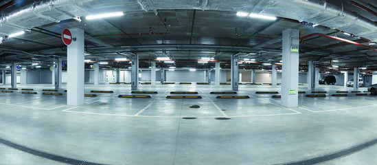 Panoramic image of new clean underground parking lot