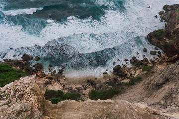 The rocky coast of the island of Bali. Wave, the ocean, evening, clouds.