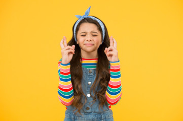 make a wish. retro girl crossed fingers. please. wait impatiently. little child yellow wall. old...