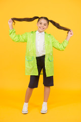 Autumn fashion for kids. dry and comfortable. Rain is not hindrance. small girl have fun in raincoat. active schoolgirl waterproof cloak. water resistant clothes. in good mood. Rainproof accessory