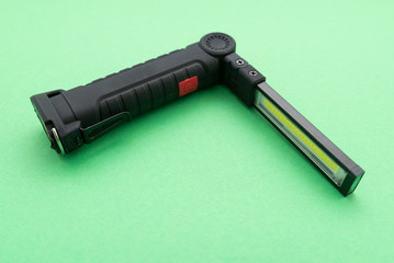 plastic flashlight on green background