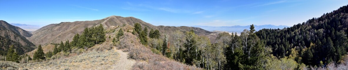 Rocky Mountain Wasatch Front peaks, panorama landscape view from Butterfield canyon Oquirrh range by Rio Tinto Bingham Copper Mine, Great Salt Lake Valley in fall. Utah, United States.