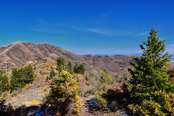 Rocky Mountain Wasatch Front peaks, panorama landscape view from Butterfield canyon Oquirrh range by Rio Tinto Bingham Copper Mine, Great Salt Lake Valley in fall. Utah, United States.