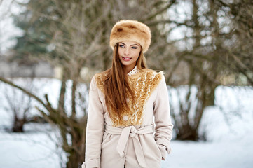 Beautiful woman walking in winter park